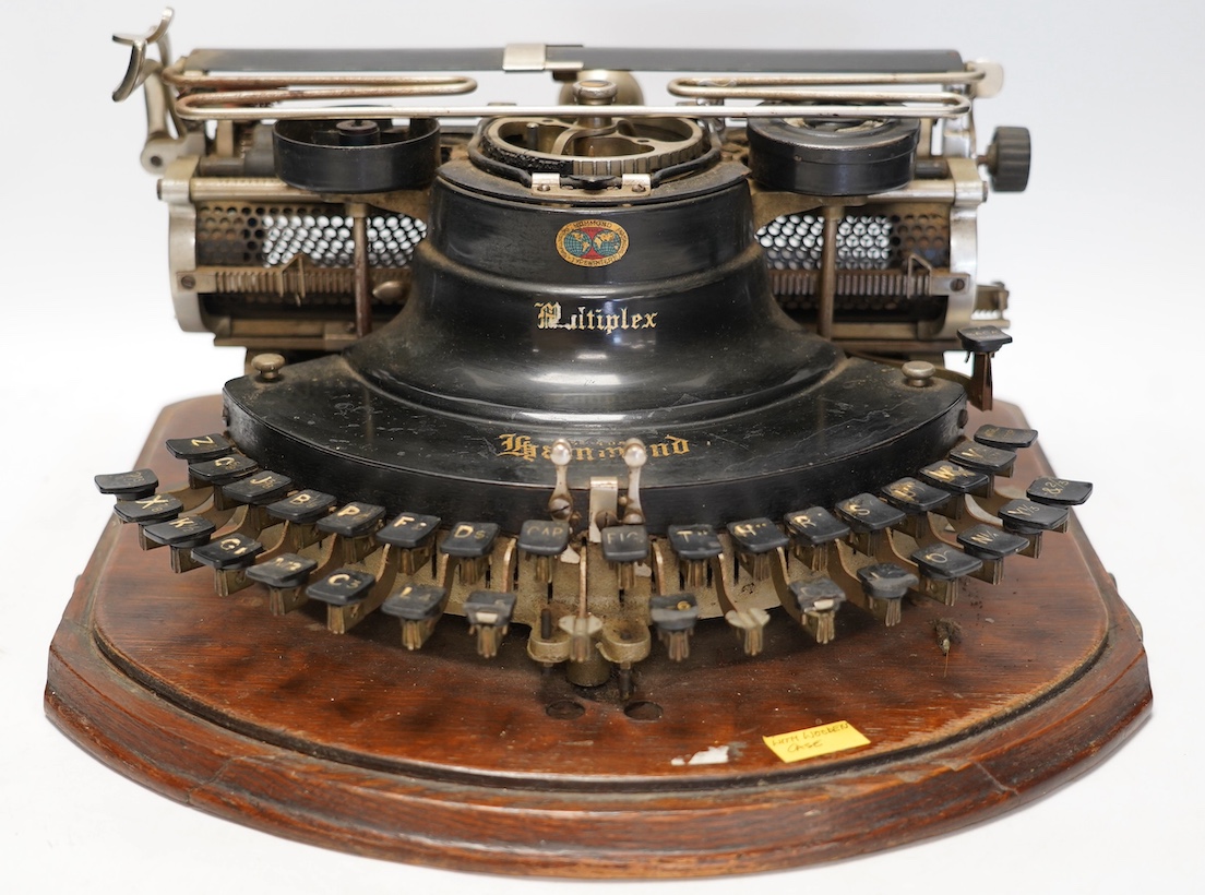 A scarce early 20th century Hammond Multiplex typewriter, with convex keyboard in an oak plywood case, case 20cm high, 35cm wide, 33cm deep. Condition - poor to fair, two keys missing and others worn or broken